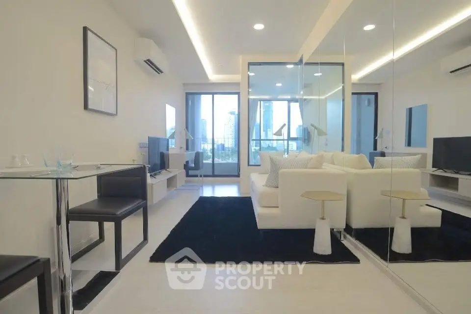 Modern living room with sleek design, large windows, and stylish furniture in a high-rise apartment.