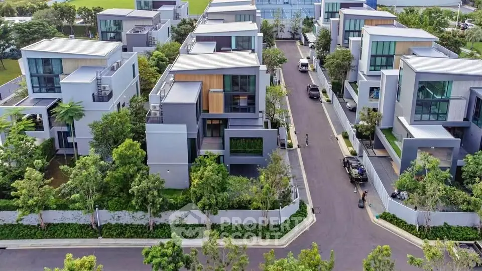 Luxurious modern villas with lush greenery and sleek architecture in a serene neighborhood.