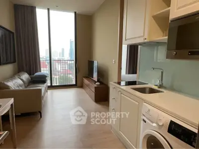 Modern apartment with open kitchen and living room, featuring a washing machine and city view.