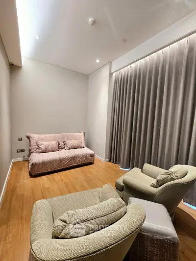 Cozy living room with plush seating and elegant curtains, perfect for relaxation.