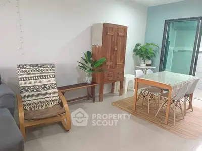 Stylish living room with modern dining area and cozy seating, perfect for family gatherings.