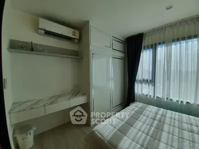 Bright and cozy bedroom with modern furnishings and large window