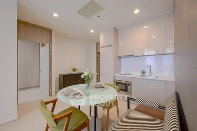 Modern kitchen with sleek cabinets and cozy dining area in a stylish apartment.