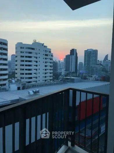 Stunning cityscape view from a high-rise balcony at sunset, perfect for urban living.