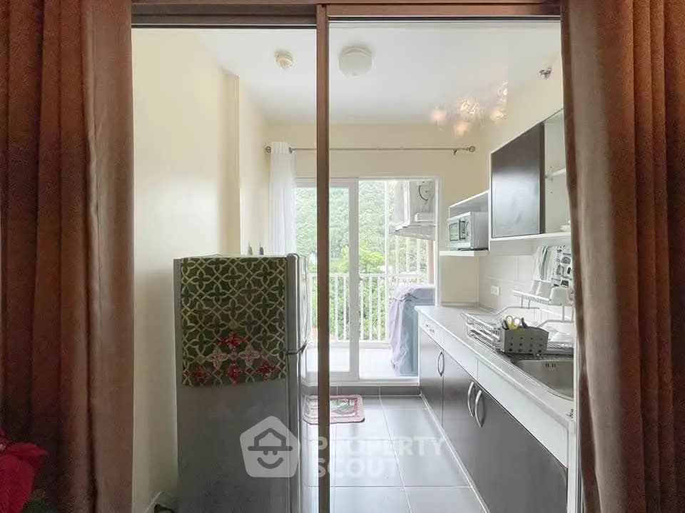 Modern kitchen with balcony view and sleek cabinetry