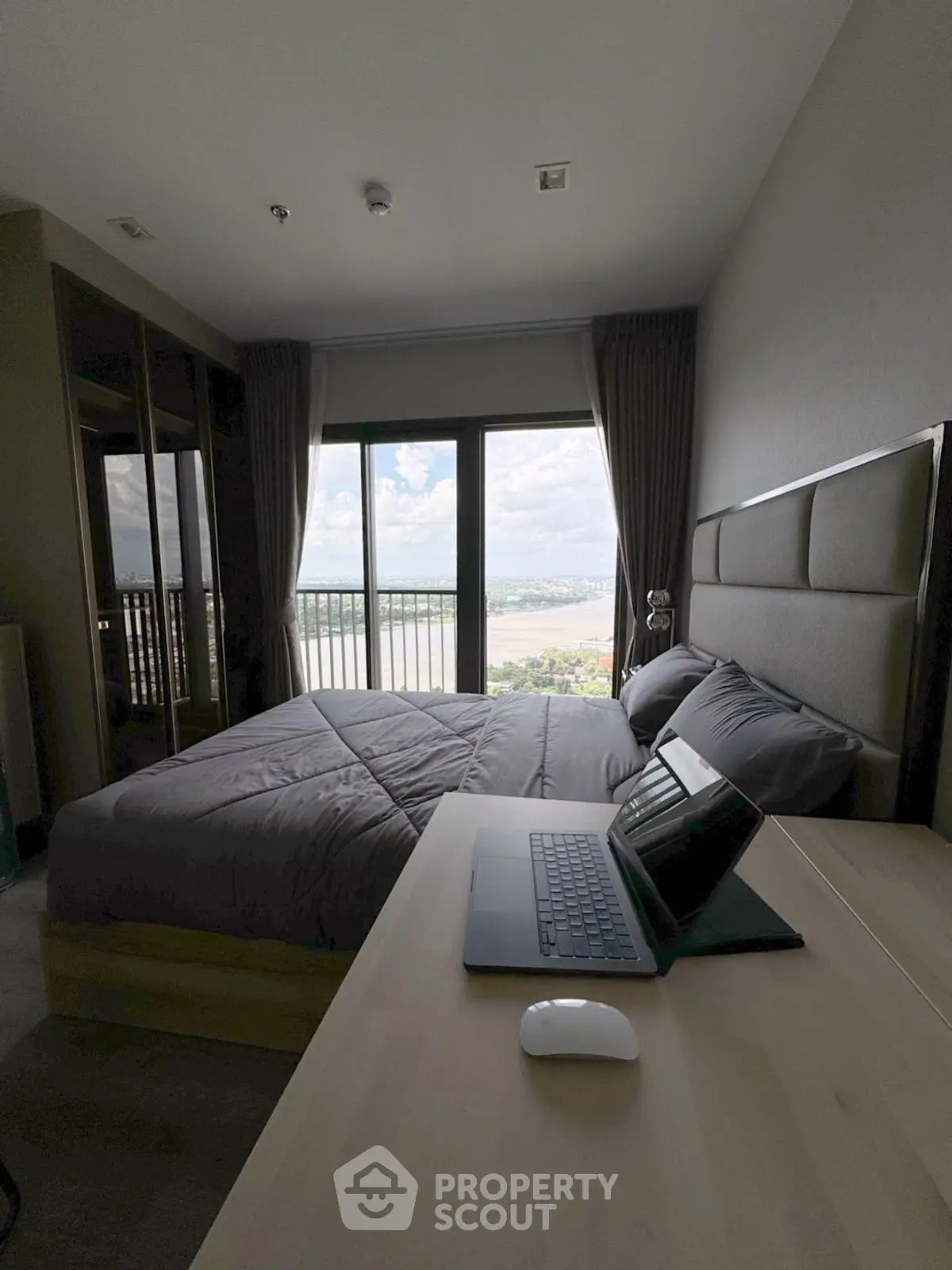 Modern bedroom with stunning river view and sleek workspace