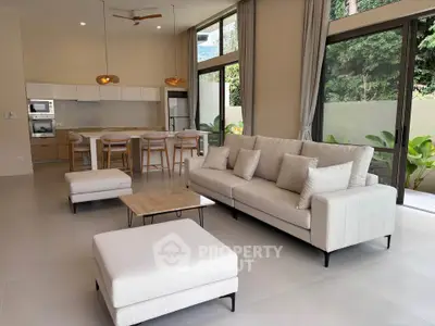 Spacious modern living room with open kitchen and large windows