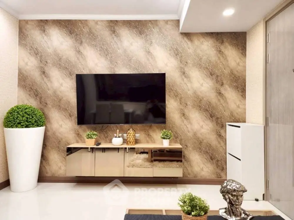 Modern living room with stylish decor and wall-mounted TV, perfect for relaxation and entertainment.