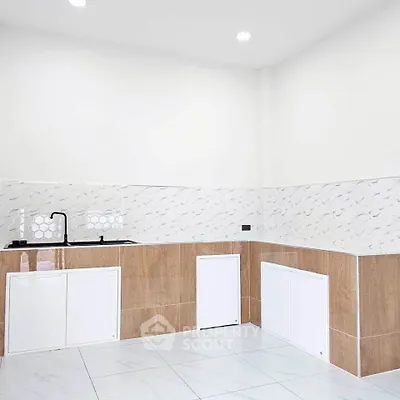 Modern minimalist kitchen with sleek white cabinets and stylish backsplash