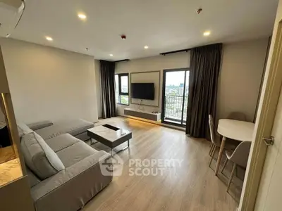 Modern living room with large sofa and balcony view in stylish apartment