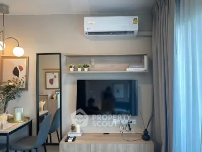 Modern living room with stylish decor, wall-mounted TV, and air conditioning unit.