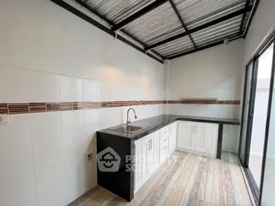 Modern kitchen with sleek countertops and stylish backsplash in a bright, open space.