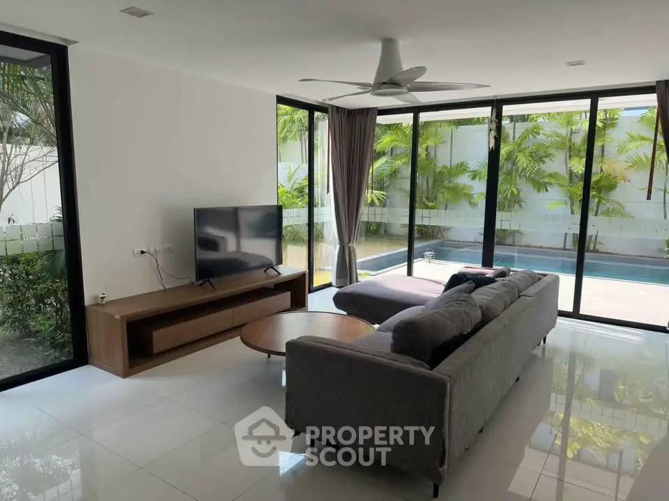 Modern living room with pool view and sleek furniture