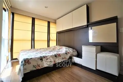 Cozy bedroom with modern furniture and large windows for natural light