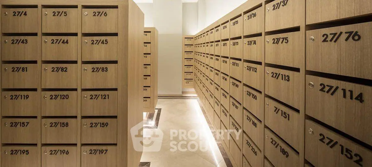 Modern apartment building mailroom with sleek wooden mailboxes and ambient lighting.