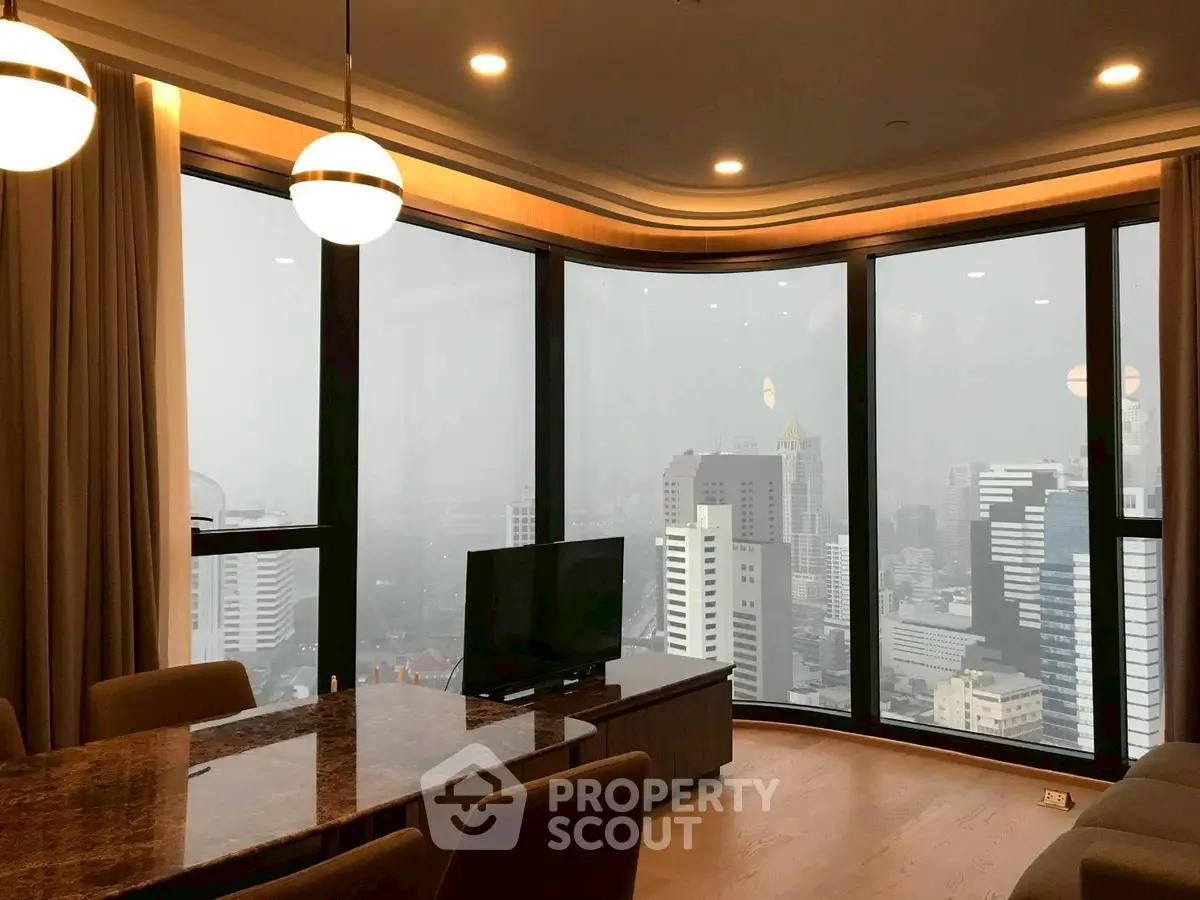 Luxurious high-rise living room with panoramic city views and elegant decor.