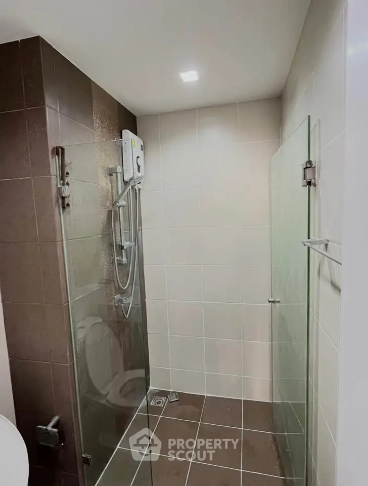Modern bathroom with glass shower enclosure and sleek tile design
