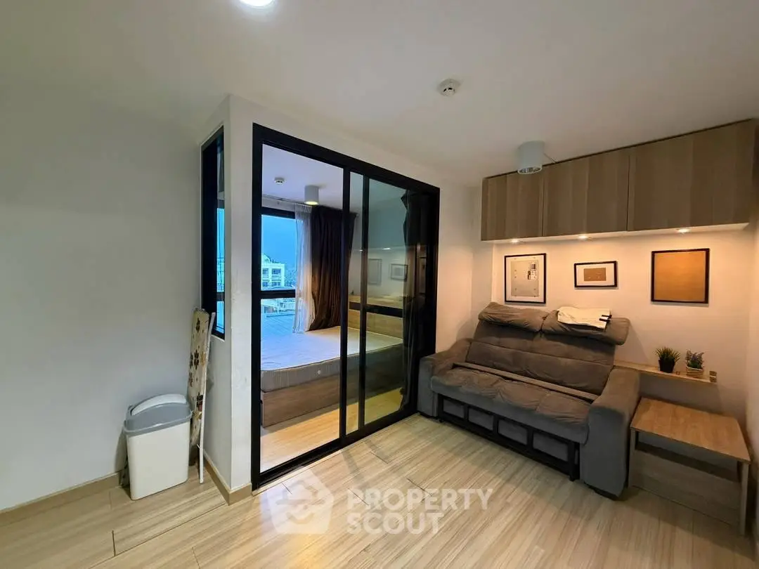 Modern living room with glass partition and cozy sofa in stylish apartment