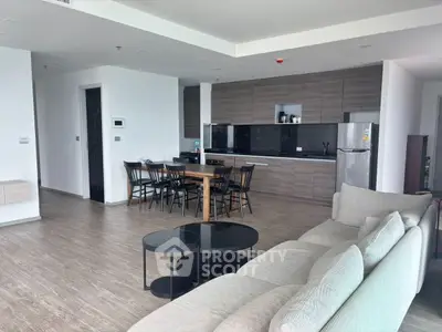 Spacious modern living room with open kitchen and elegant furnishings