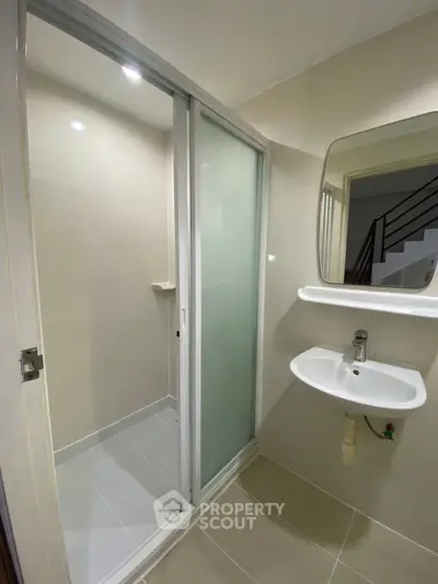 Modern bathroom with sleek shower and minimalist sink design