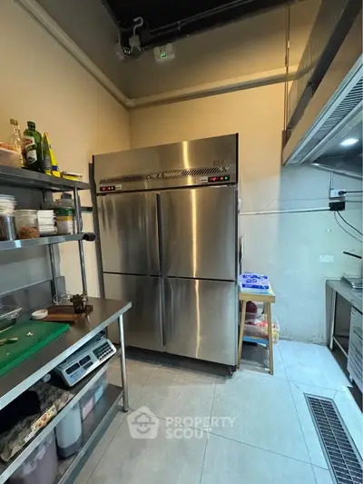 Commercial kitchen with stainless steel appliances and shelving