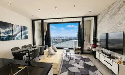 Luxurious living room with stunning city view, modern decor, and spacious seating area.