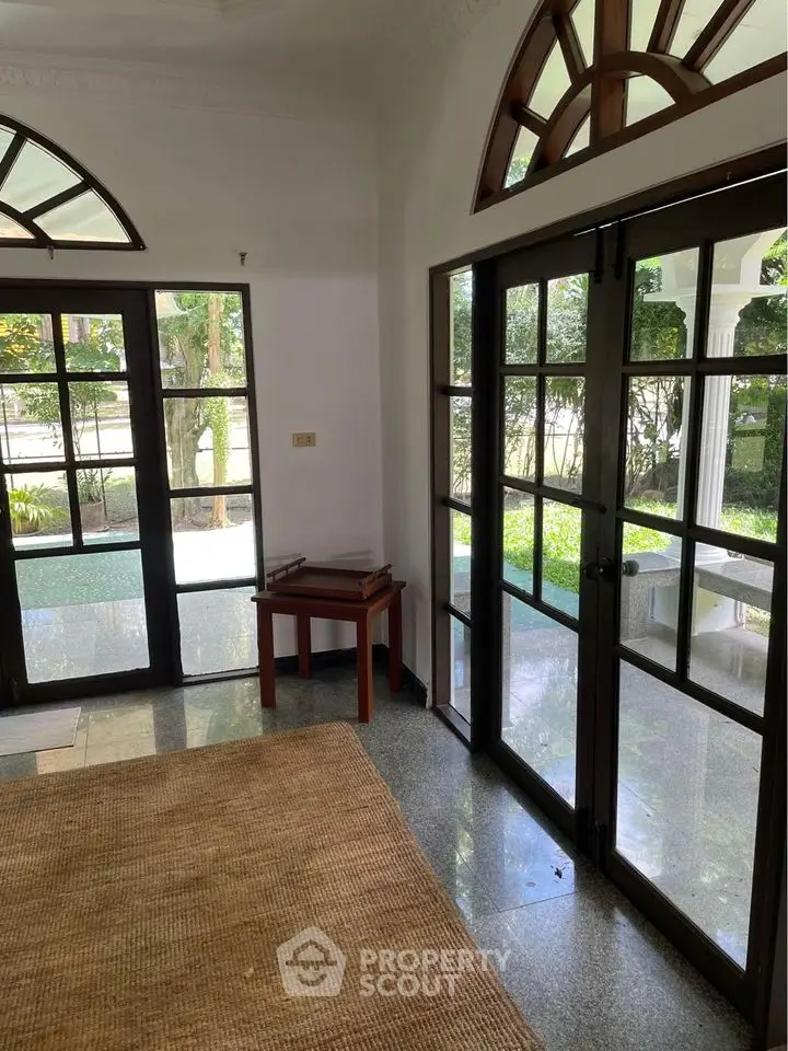 Elegant interior with large windows and garden view, perfect for natural light lovers.