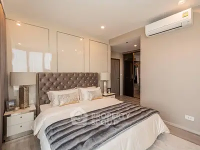 Luxurious bedroom with plush bedding and modern decor, featuring a walk-in closet and air conditioning.