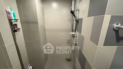 Modern tiled bathroom with shower and storage shelves