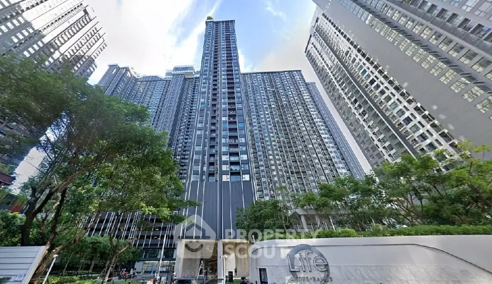 Stunning high-rise residential building with modern architecture and lush greenery in urban setting.