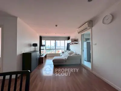 Spacious living room with city view and modern furnishings