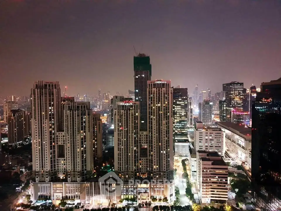 Stunning cityscape view of illuminated skyscrapers at night, showcasing urban living and modern architecture.