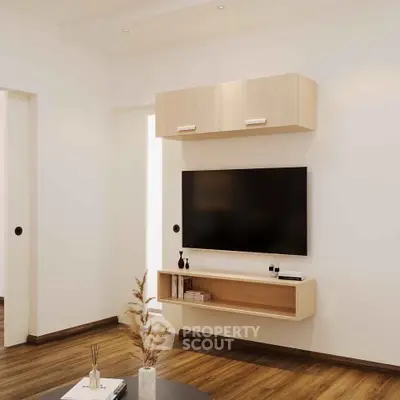 Modern living room with sleek TV setup and wooden flooring, perfect for contemporary living.
