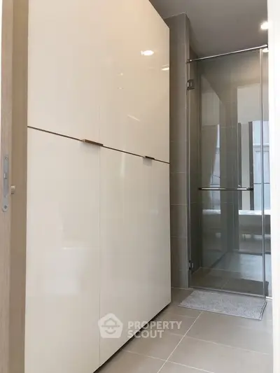 Modern bathroom with sleek shower and ample storage space