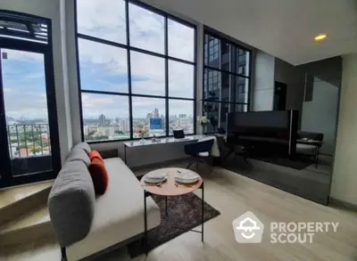 Modern living room with floor-to-ceiling windows and stunning city view.