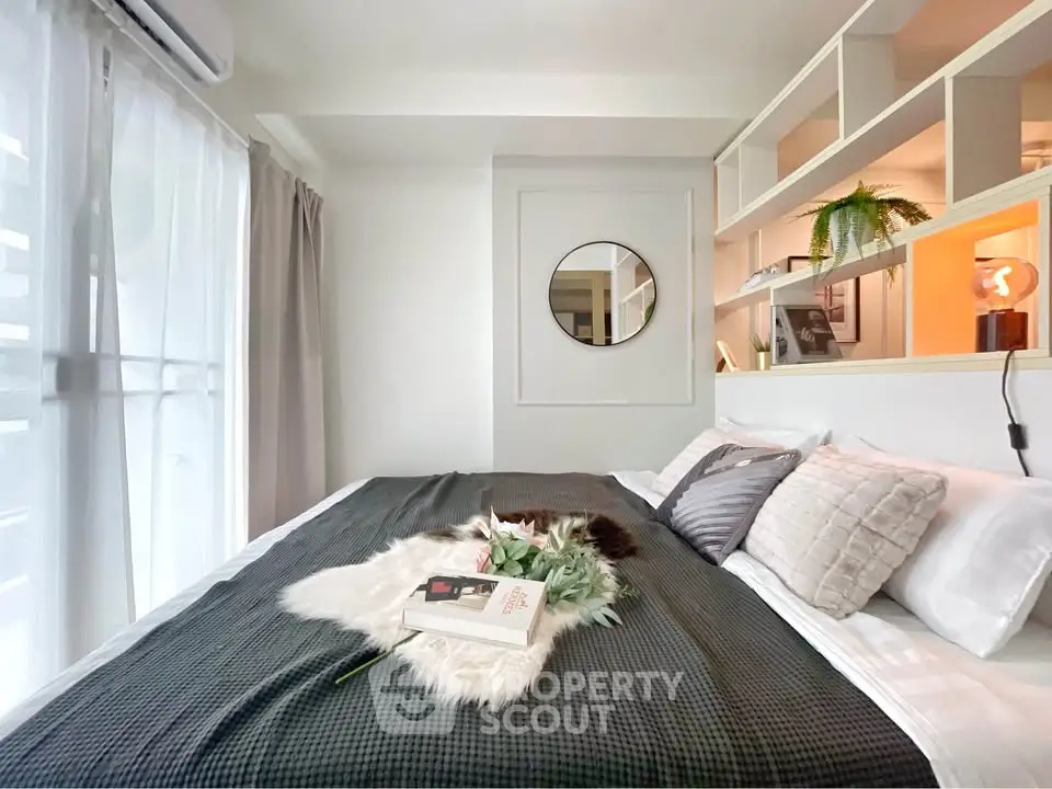Cozy bedroom with stylish decor and natural light, perfect for relaxation and comfort.