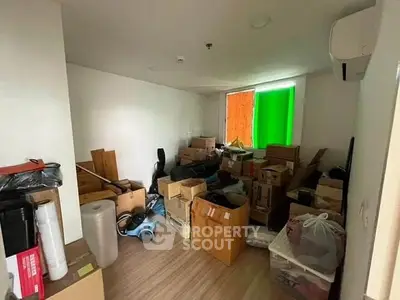 Spacious storage room filled with moving boxes and household items, ideal for organizing belongings.