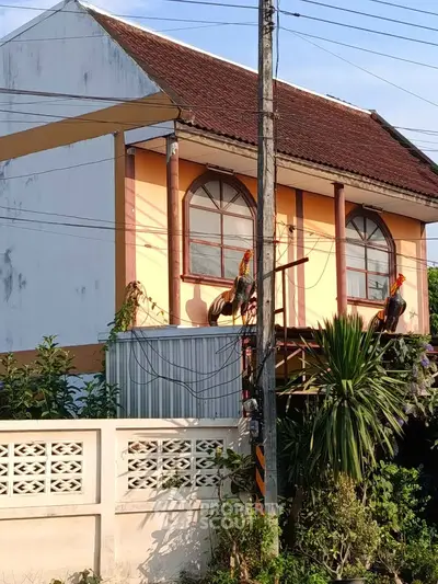 Charming two-story house with unique architectural design and lush greenery in a serene neighborhood.