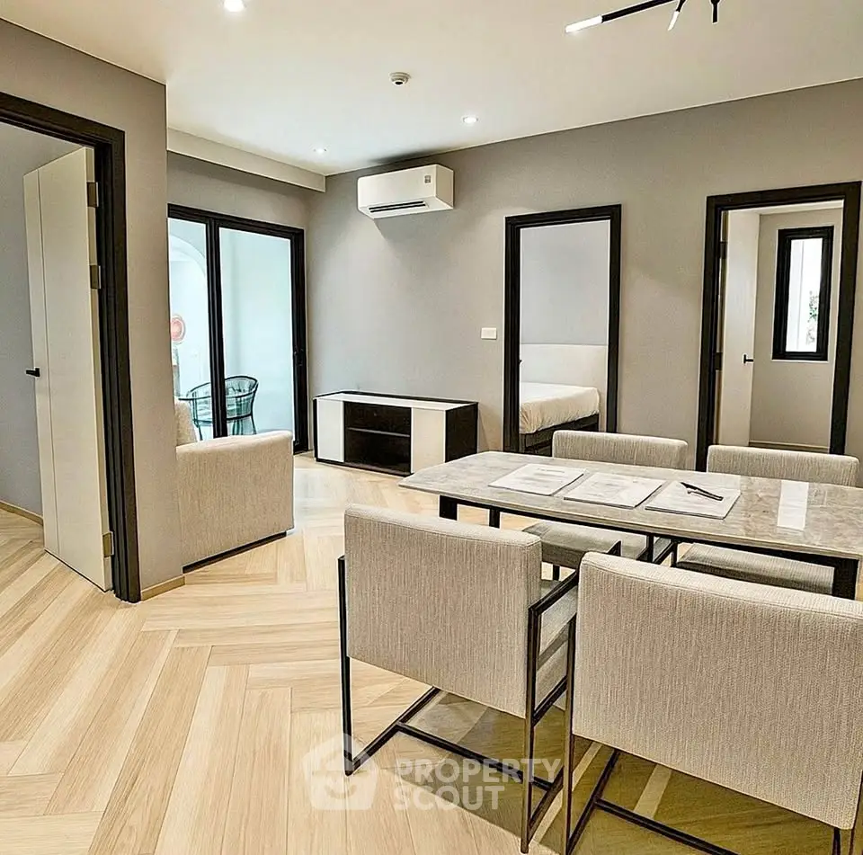 Modern open-plan living and dining area with sleek furniture and neutral tones.