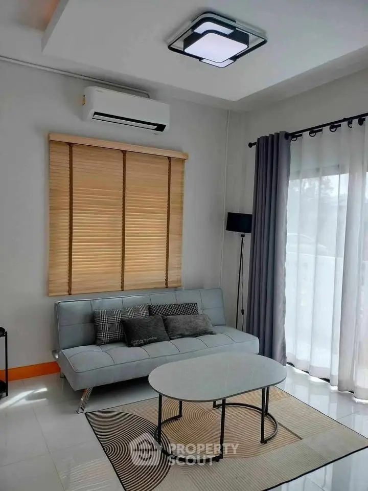 Modern living room with sleek sofa, stylish coffee table, and elegant lighting, perfect for contemporary living.