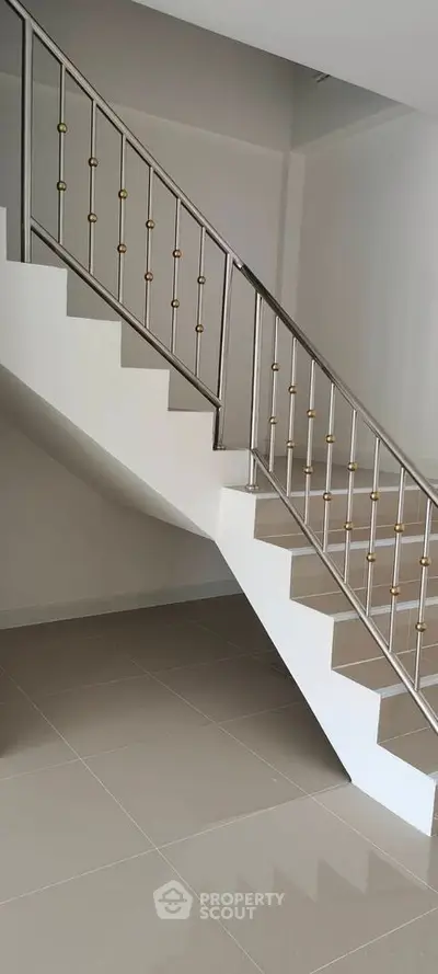 Modern staircase with sleek metal railing in a contemporary home interior