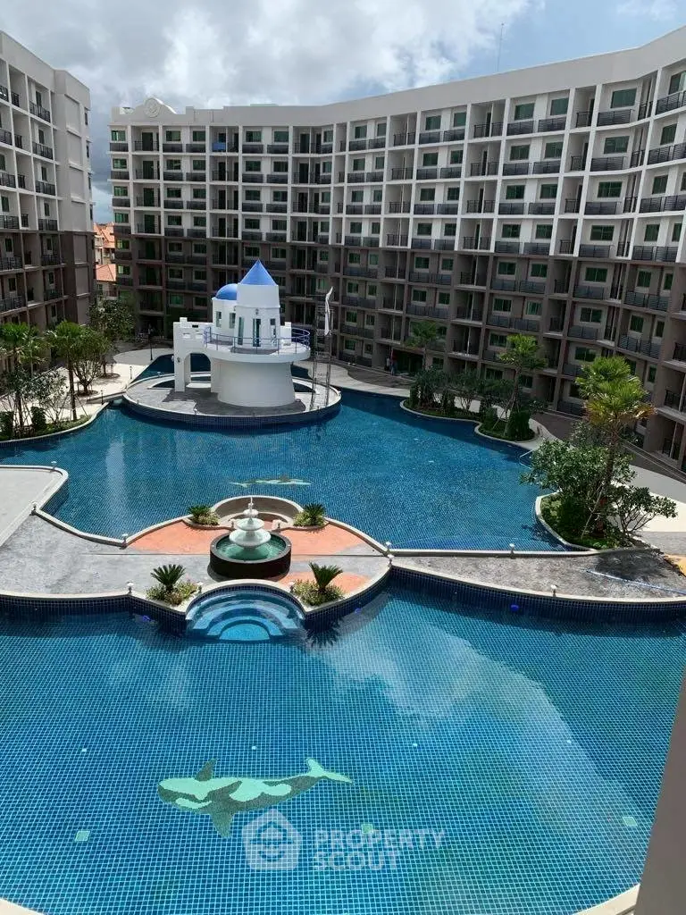 Luxurious apartment complex with stunning pool and unique architectural design.