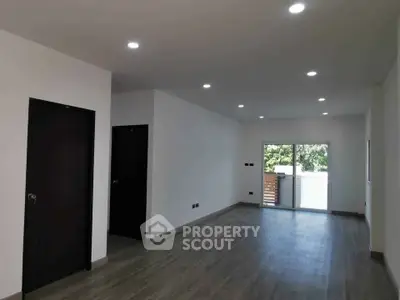 Spacious modern living room with large windows and sleek flooring