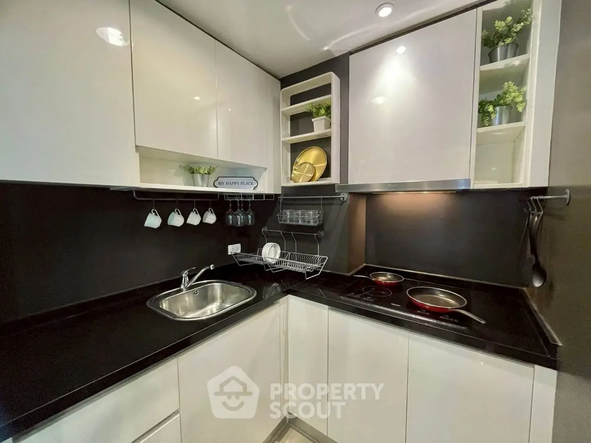 Modern kitchen with sleek black countertops and white cabinets