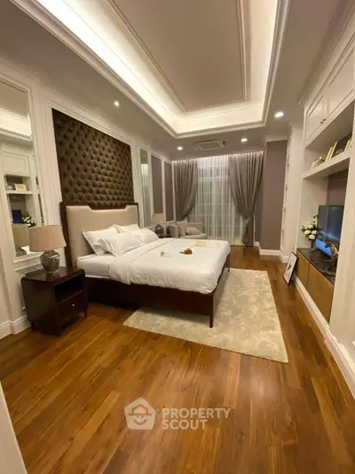 Luxurious bedroom with elegant decor and hardwood flooring