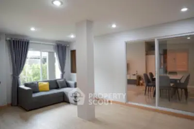 Spacious living room with modern decor and large windows for natural light.