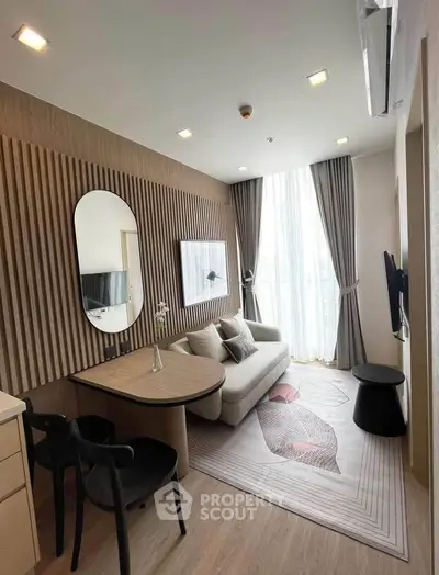 Modern living room with stylish decor, cozy sofa, and large window for natural light.