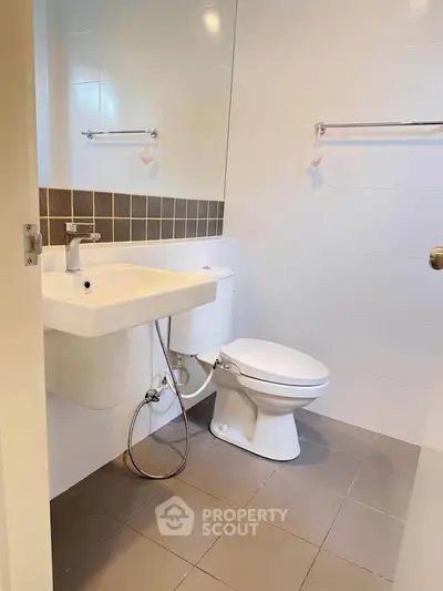 Modern bathroom with sleek fixtures and tiled walls in a contemporary home.
