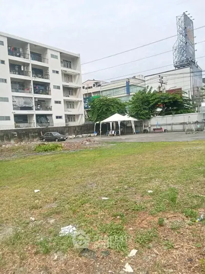 Spacious urban lot with potential for development near residential buildings.