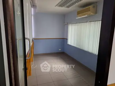 Compact office space with air conditioning and large window blinds